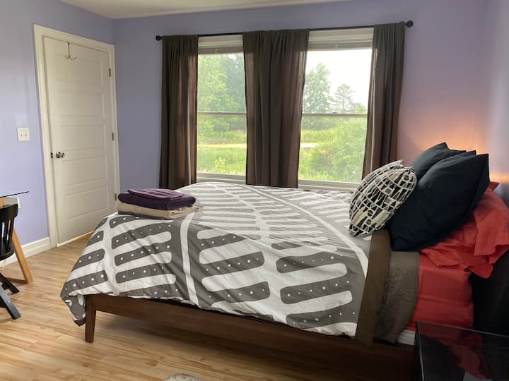 The Northeast upstairs bedroom has a queen bed with memory foam topper. Great view of the pond. This room has access to one of the lofts. 