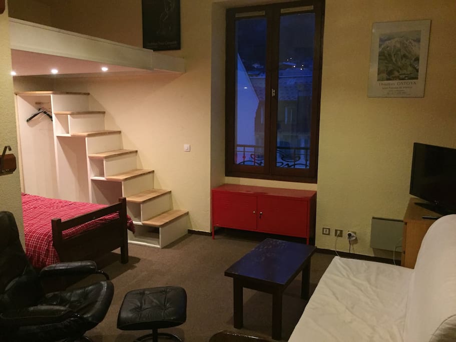 Wooden steps leading up to the mezzanine double mattress
