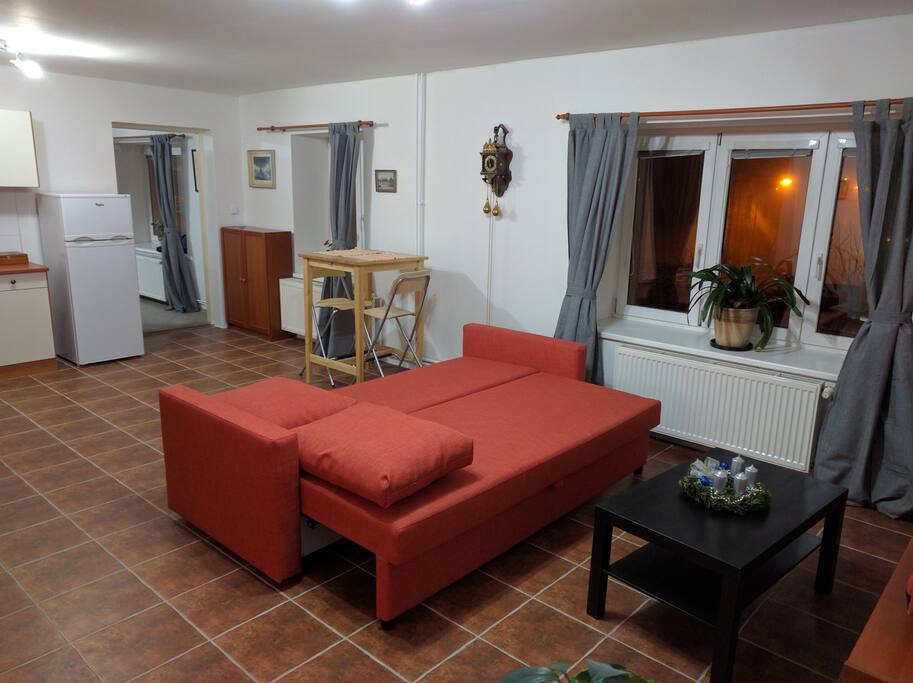 The living room pictured towards the bedroom with view on the main square. The couch converts into a bed for 2.