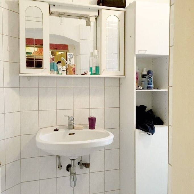 The bathroom with sink and a mirror (extra lights above)