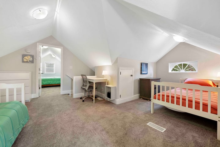 El dormitorio infantil abierto y divertido y el área de juegos también son una oficina donde puedes trabajar mientras observas a los niños.