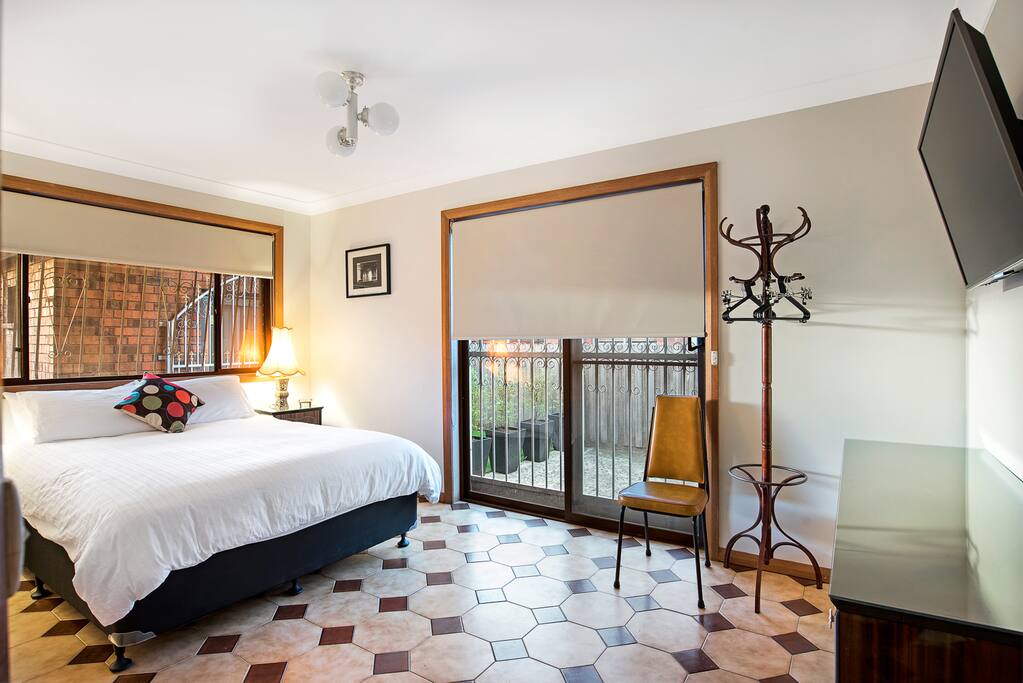 Valentino Room with queen bed & wall-mounted smart tv