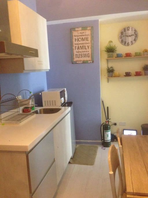 kitchen with microwave, ref, rice cooker and kettle