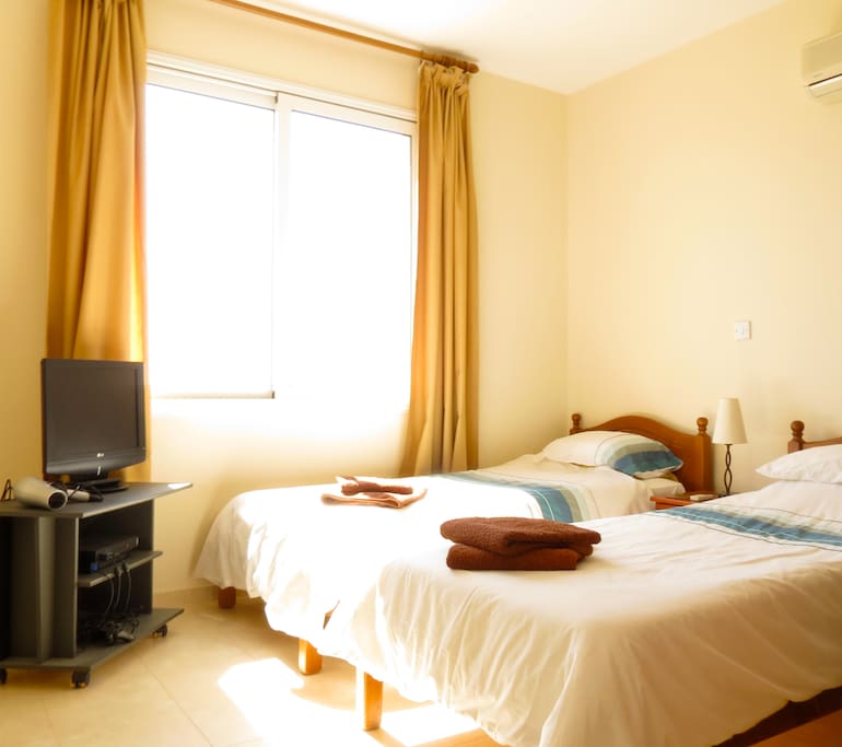 twin bedroom air conditioned and flyscreens on window with TV and Playstation. En-suite bathroom