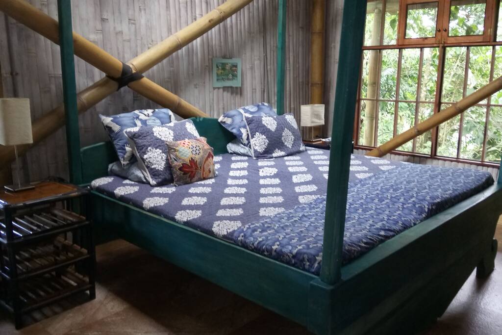 King-sized Java bed in private bedroom. Views of jungle and garden.