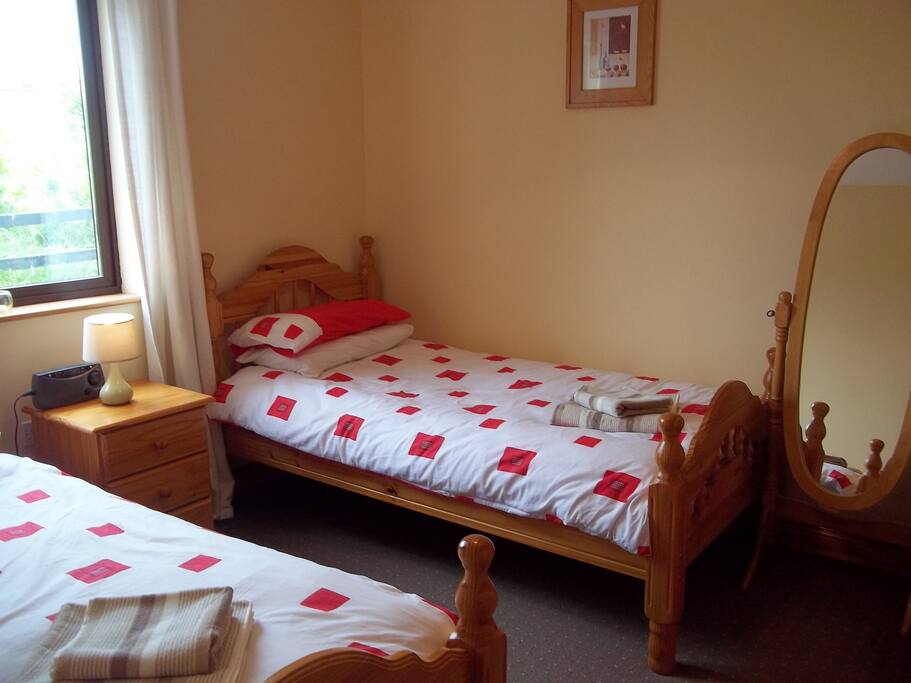 Twin bedroom including wardrobe and shelves.