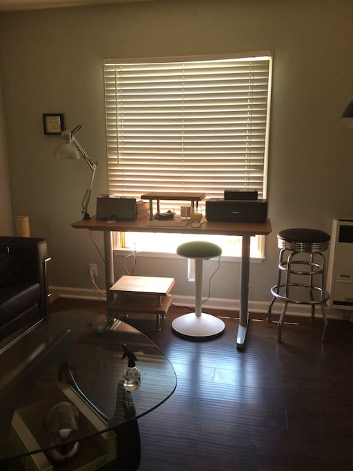 Standing desk with stools for two as a workspace.