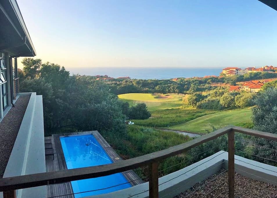 Pool, sea and golf course view