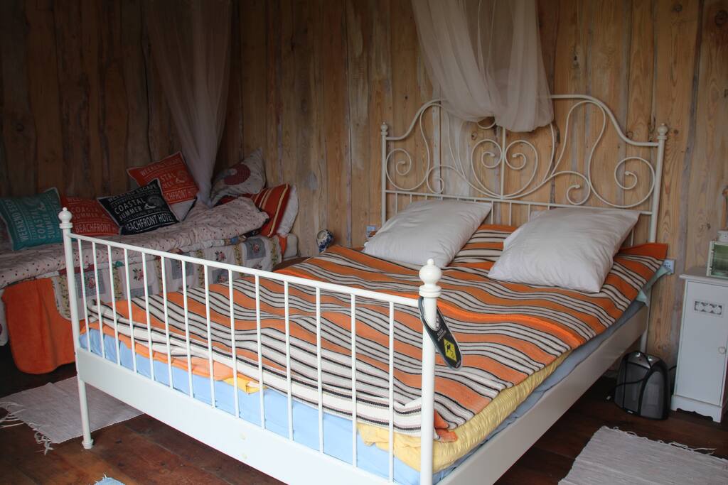 Glasshouse, equipped with a queen sized bed and a single bed
