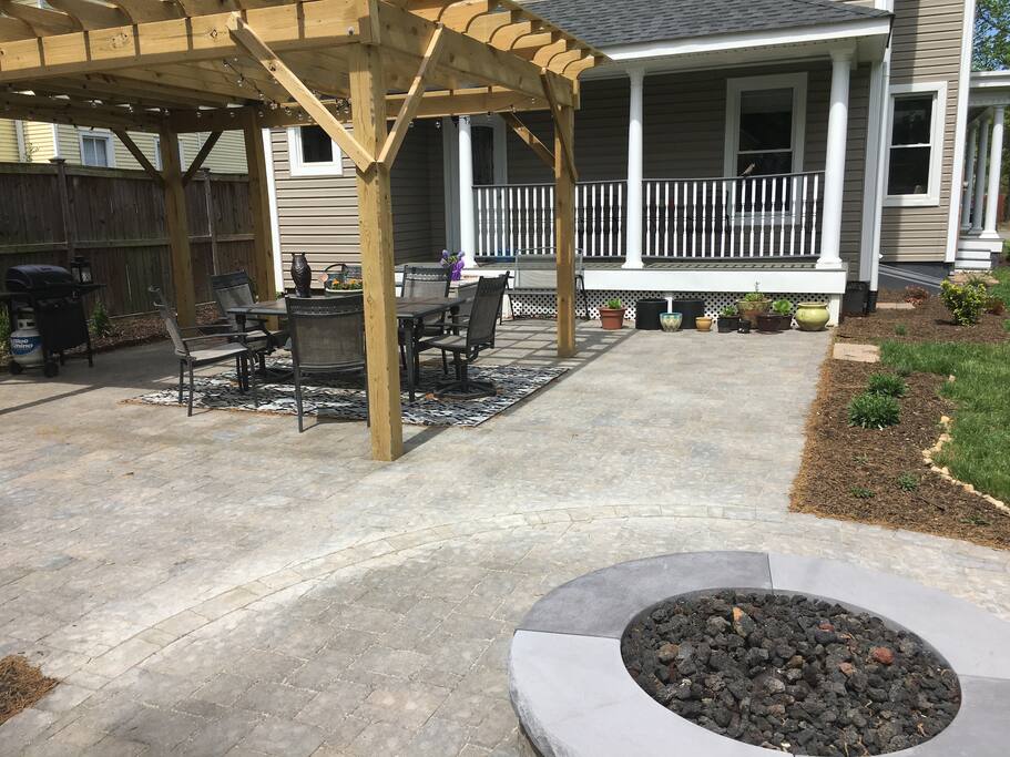 Outdoor patio with firepit in the foreground.