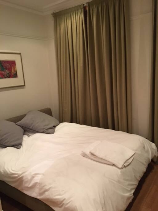 Master bedroom with king bed and large windows. Curtains keep the sun out for sleeping late! All cotton linens for luxury.