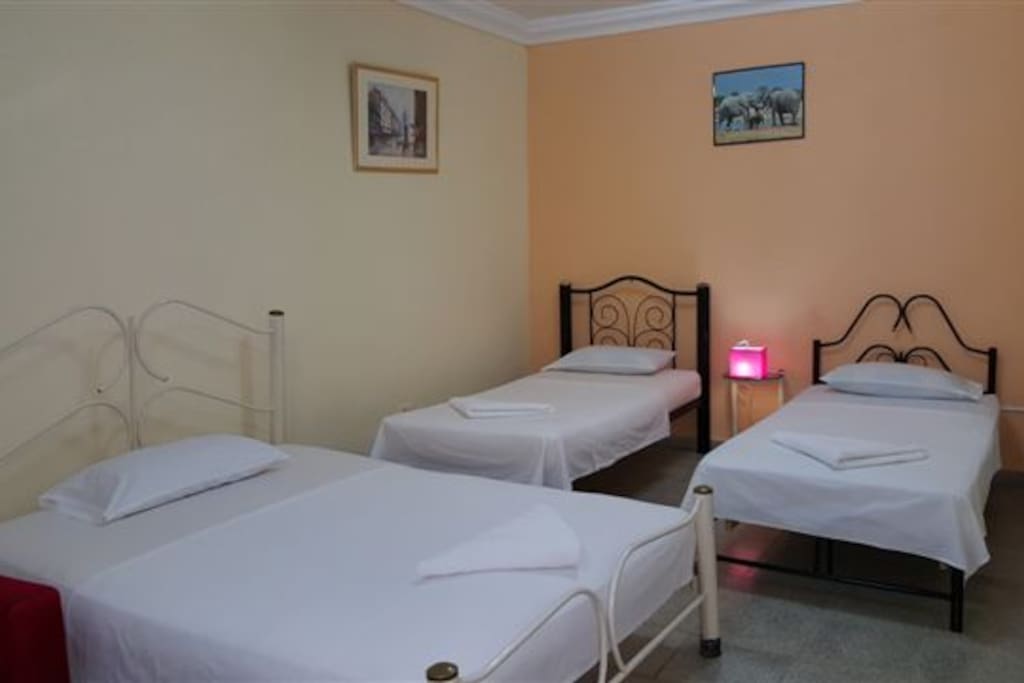 A double bed and two single beds in the bedroom