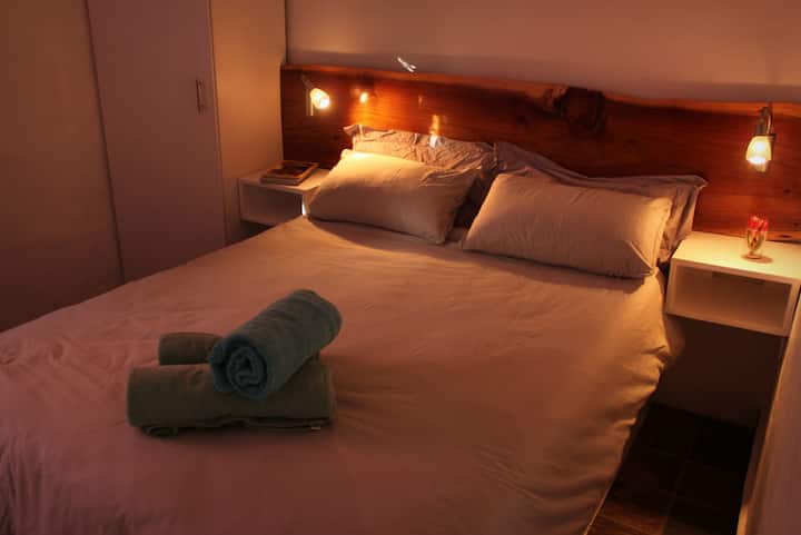 A comfortable double bed with night lights and hanging/shelved space for clothing.  Power plugs available at each bed for device charging. #comfy #bed