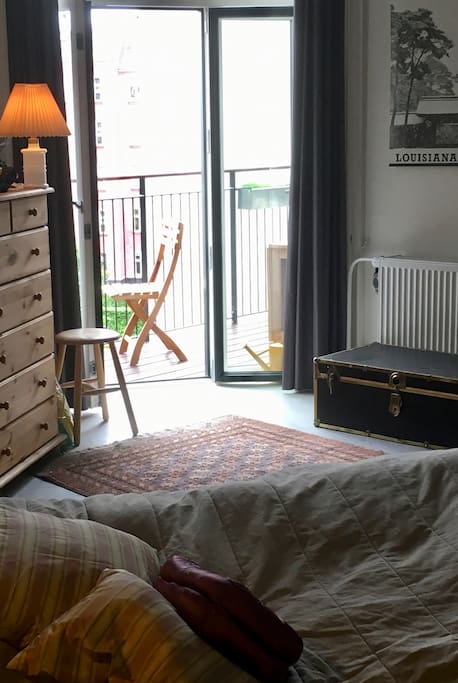 Master bedroom with balcony facing towards backyard