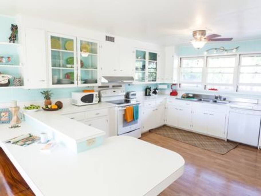Bright kitchen opens to lanai via french doors