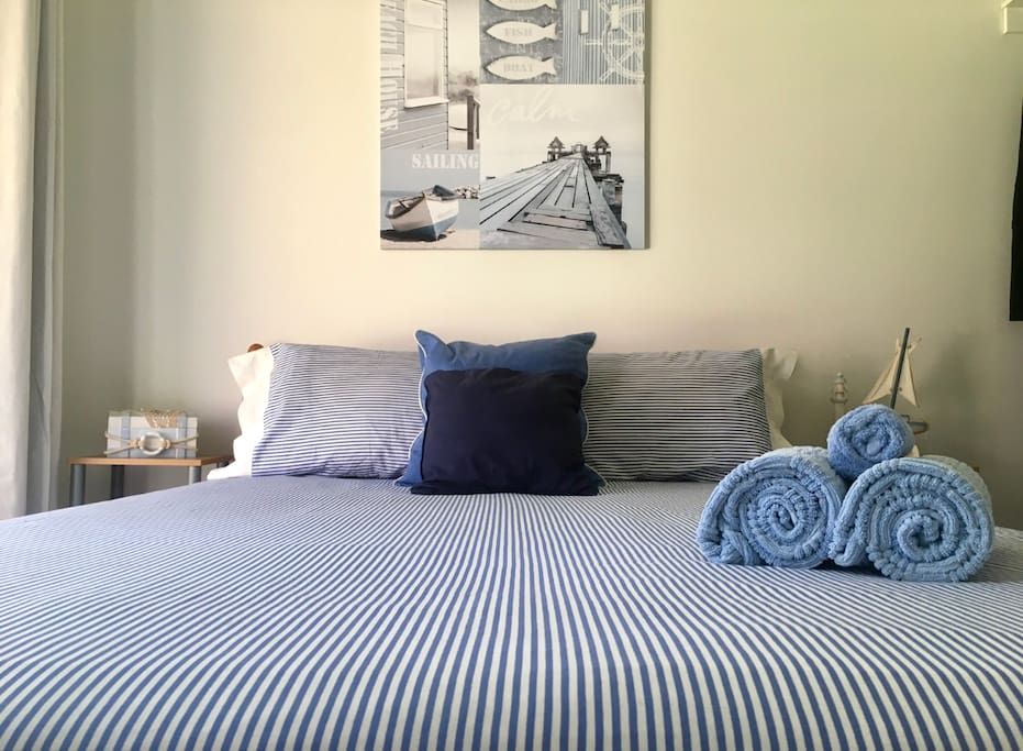Master bedroom. 1 Q bed with open wardrobe inc drawers. Sliding door into front courtyard.