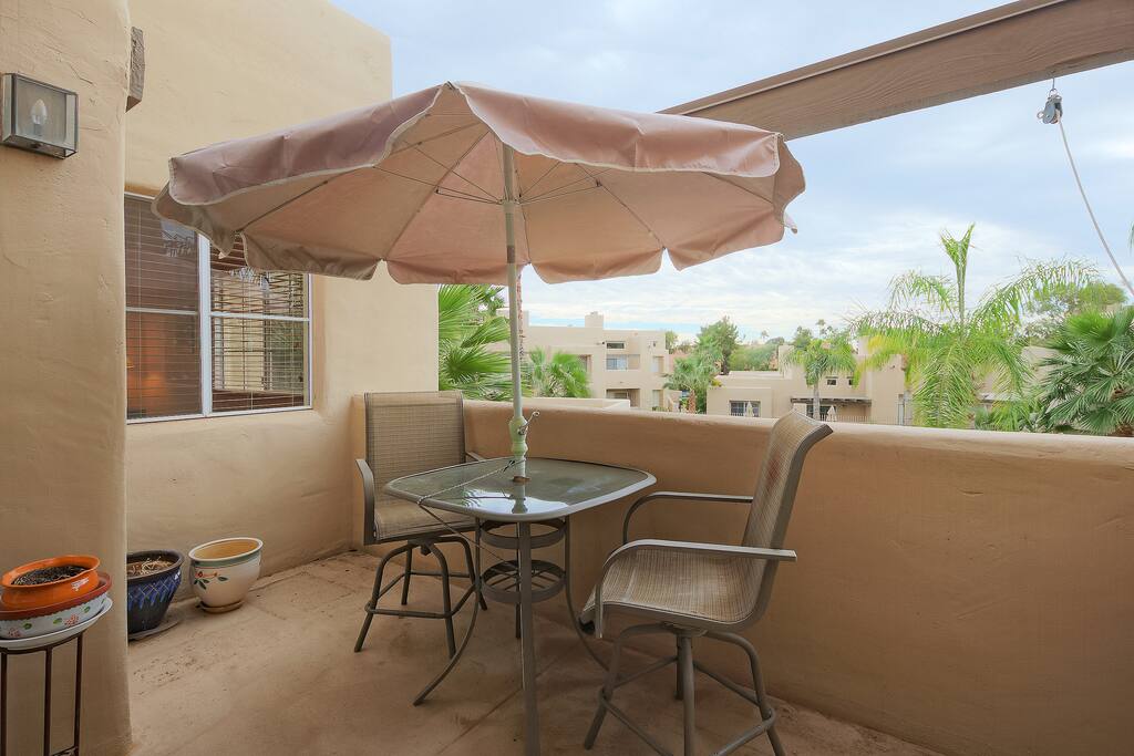 Private balcony with seating for 2 overlooking the pool.