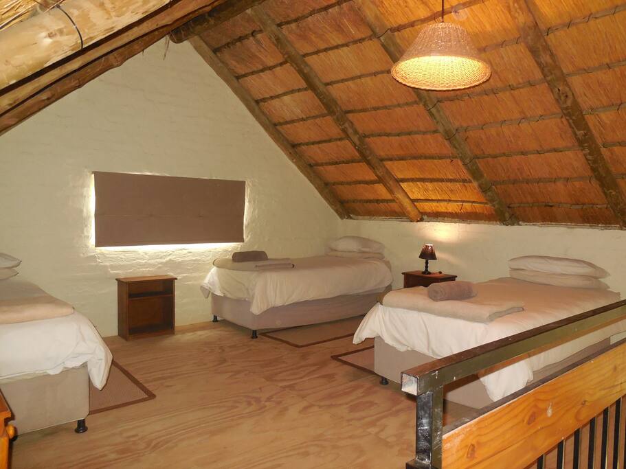 Loft bedroom with 3 single beds
