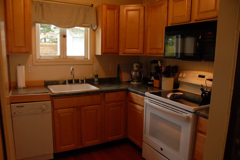 Kitchen with GE Range, warming burner and convection oven.