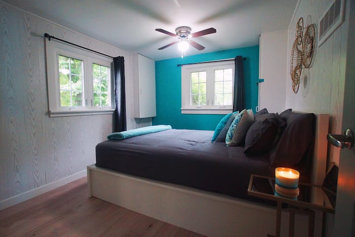 Bedroom 2 with Queen Size bed, ceiling fan and extra blanket. 