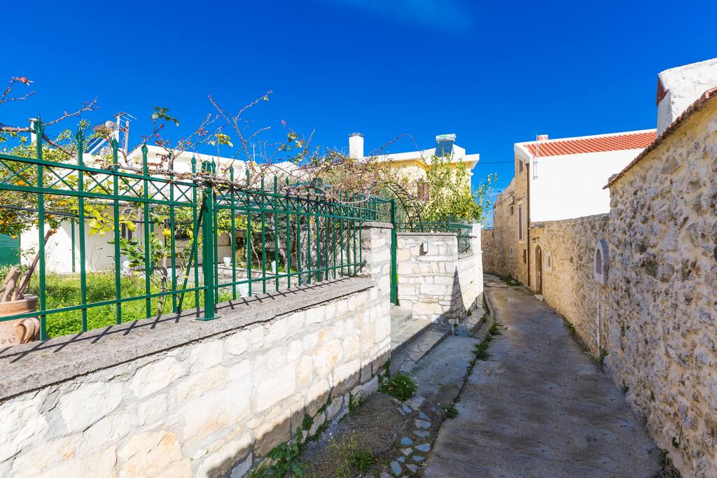 The narrow stone- built street which drives to the house