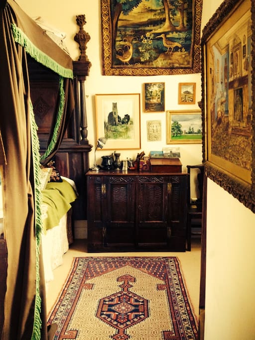 Four poster bedroom with Tudor oak furniture and lots of paintings. There is a double en-suite shower in this room.