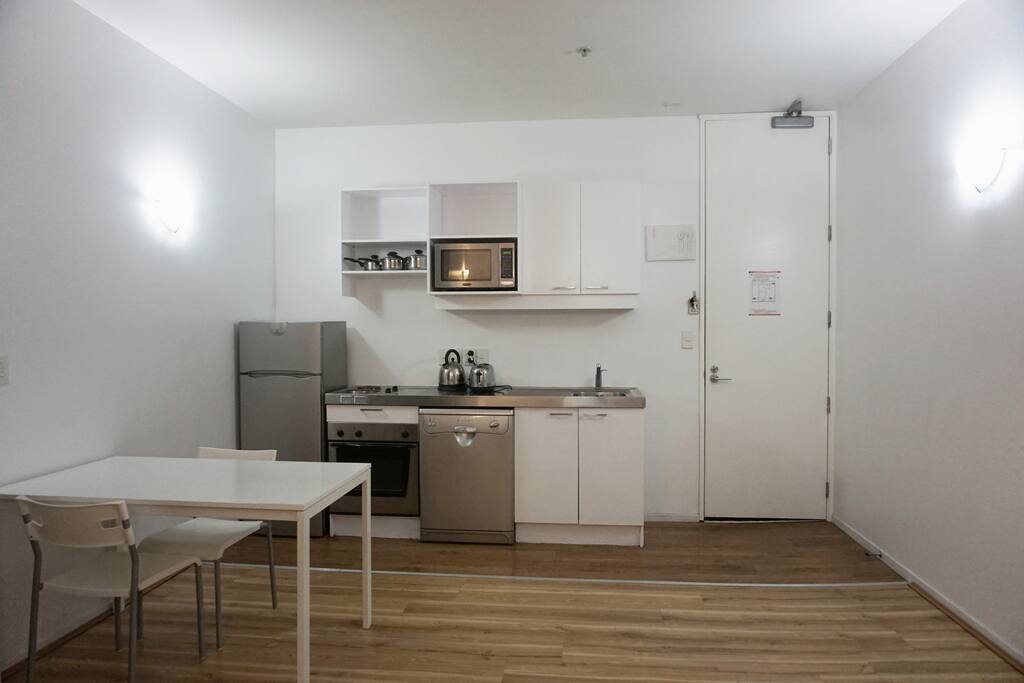 Fully functional kitchen with pots, plates, bowls, cups and cutlery.