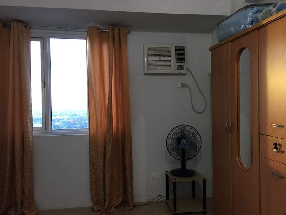 With acu, clothes cabinet, and windows with a view of Quezon City.