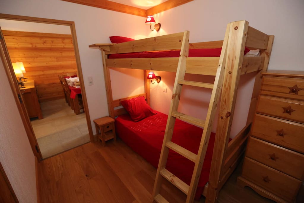 Chambre avec deux lits superposés ambiance chalet et de nombreux rangements