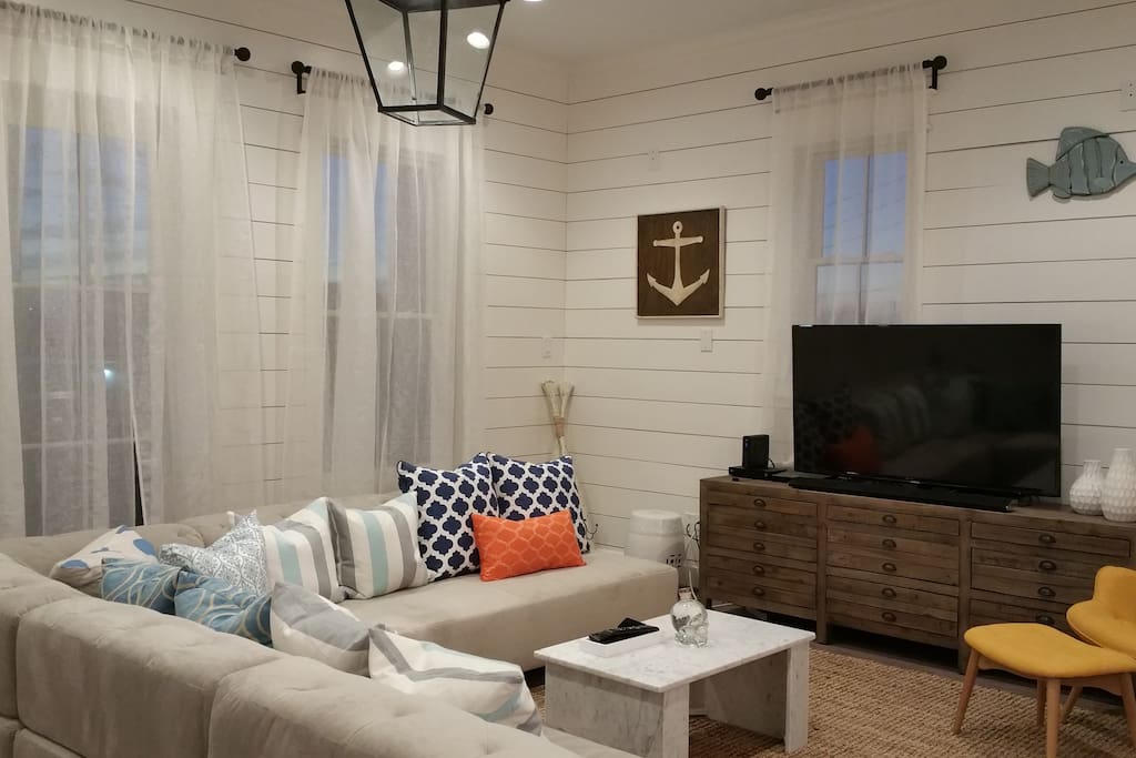 Living room: 55" Smart HDTV, DVD, and Sound Bar System.