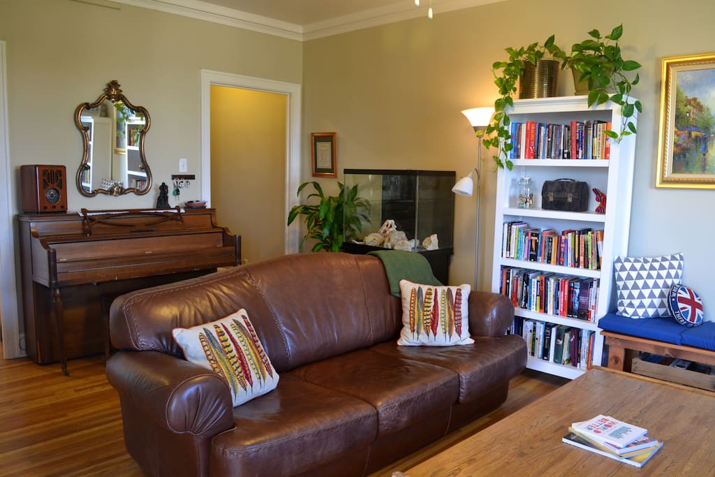 Bright, spacious living room, complete with piano. The leather couch is extremely comfortable for both lounging and napping on.