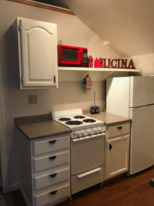 Stove, microwave, refrigerator side of kitchen
