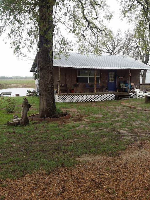 view of cabin with lake in back