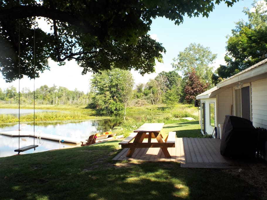 Picnic table and gas grill on the lakeside deck.