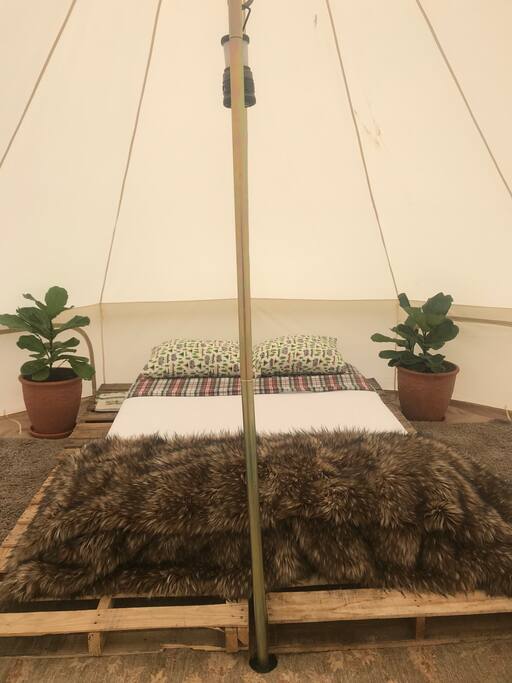 Queen bed with linen sheets, comfortable hypoallergenic pillows, and a faux bear quilt to keep you and your loved one nice and toasty on cold nights.