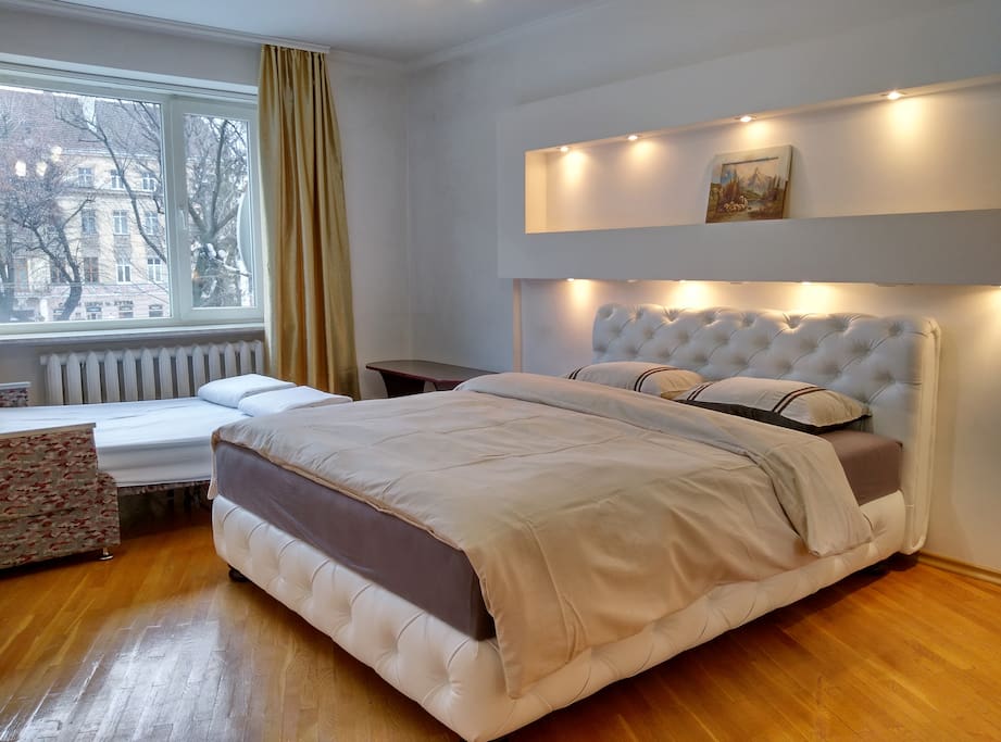First Big Bedroom (Avenue Views): King bed and double pull-out sofa (prepared on request) with the best views of lively Svoboda Avenue.