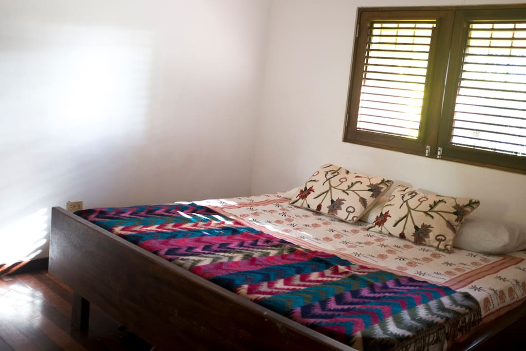 California king sized bed in a cool, quiet room with good dark curtains.