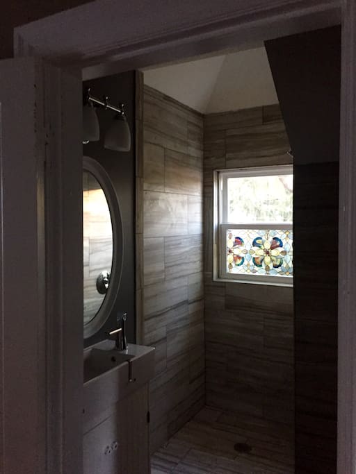 Brand new bathroom with vaulted shower stall