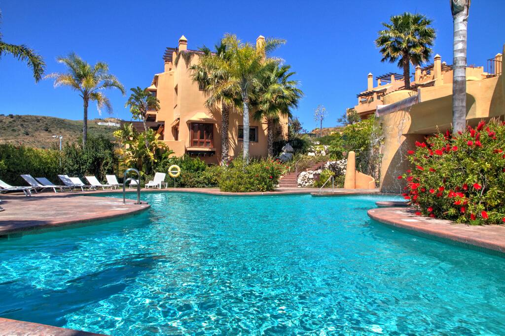 Beautiful pool with water fall and sea views in a tropical garden