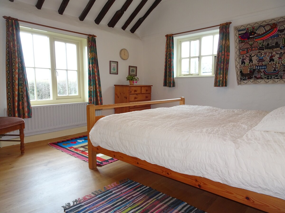 Bedroom in the original part of the house, with king bed