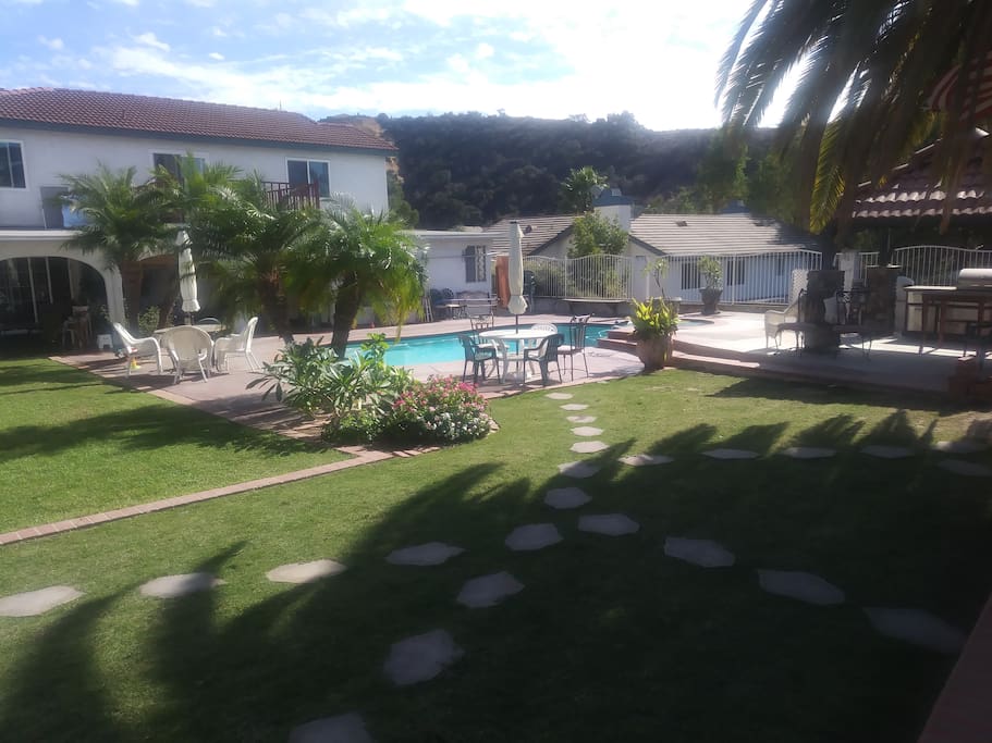 Lush Backyard Pool, Jacuzzi and Outdoor Grill/Living Areas, right outside your door!