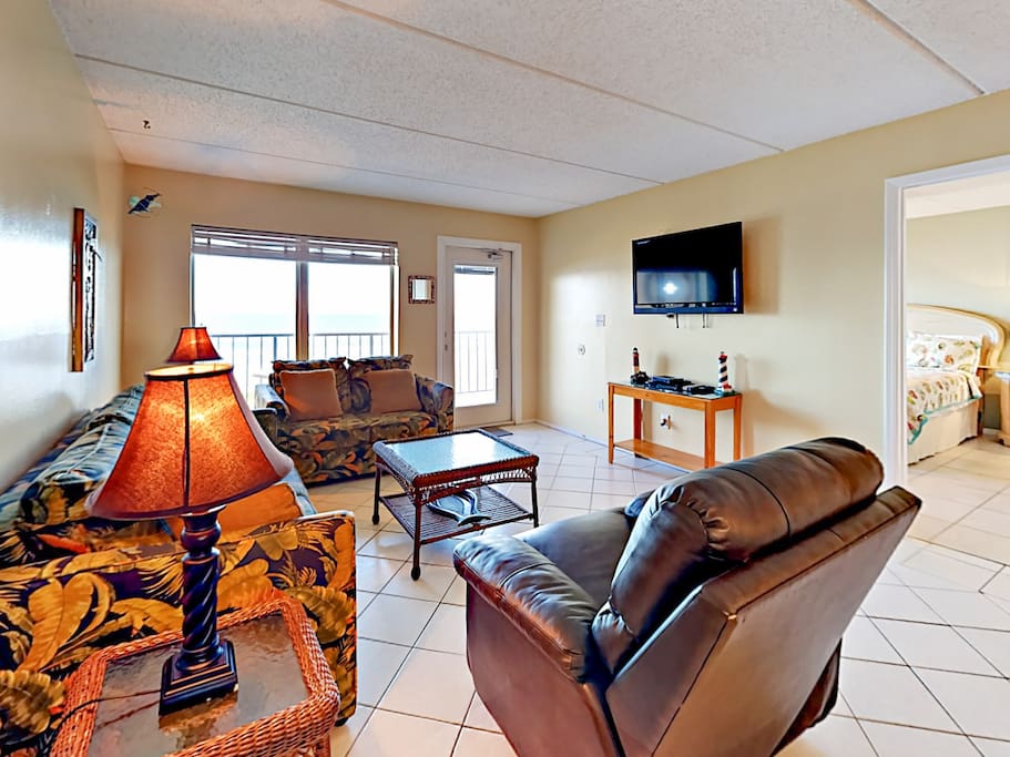 The open living area features a flat screen TV with a DVD player. Complimentary Wi-Fi provided.