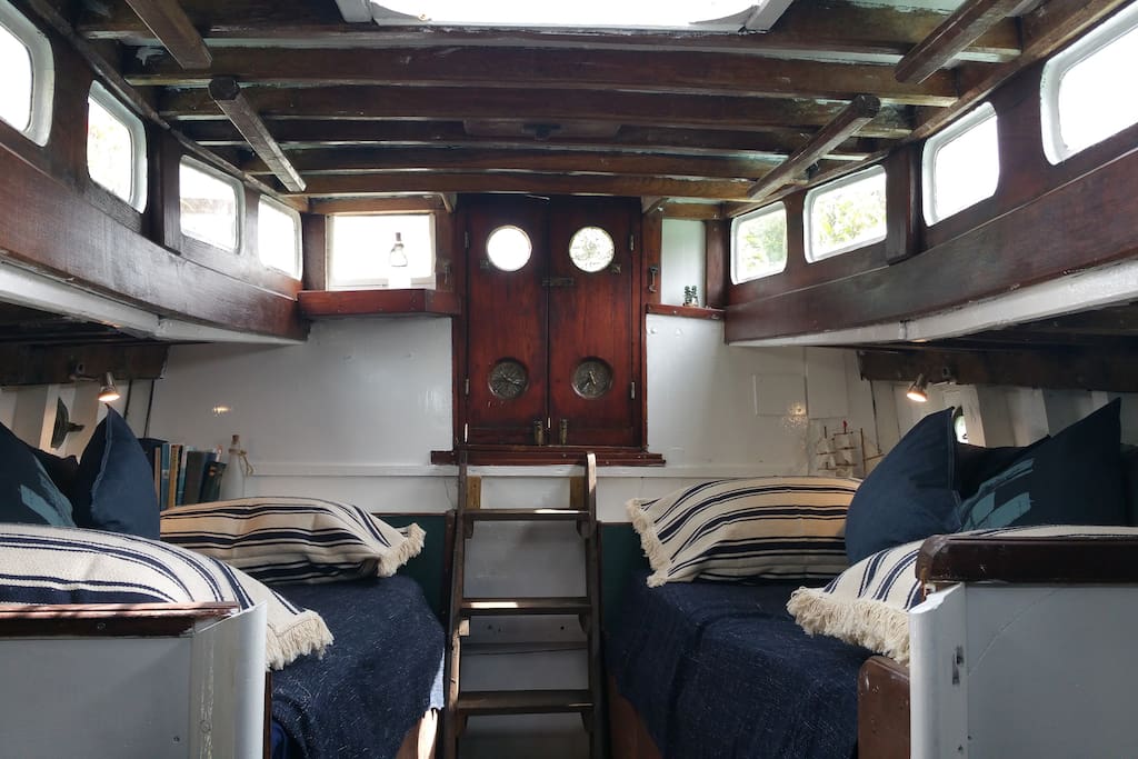 This comfy cabin can accommodate four people. There is a double bed and two single day beds, which can be converted to single beds. It is not suitable for a travel cot.