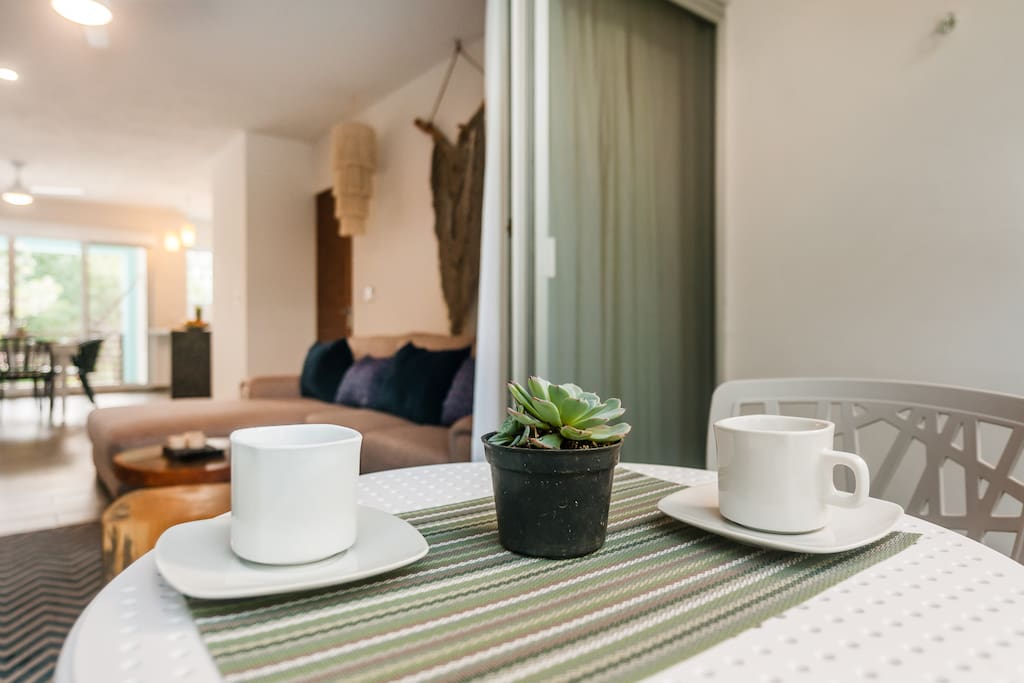Enjoy your morning coffee while listening to the sounds of the pool waterfalls