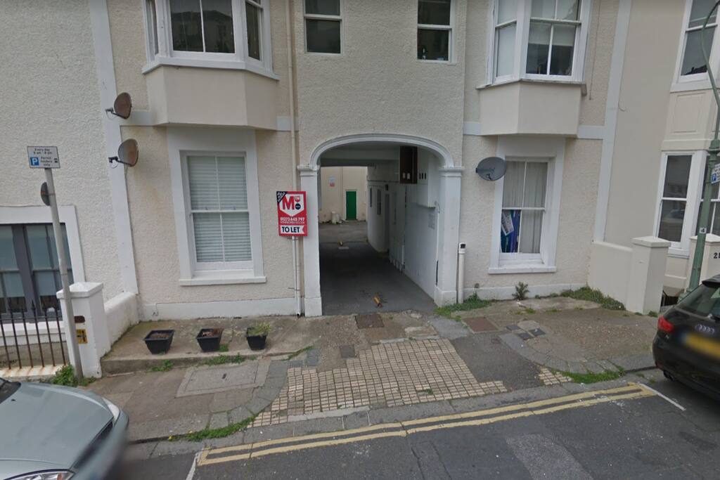 This the entrance. The front door is through the arch and immediately to the right (number 20).