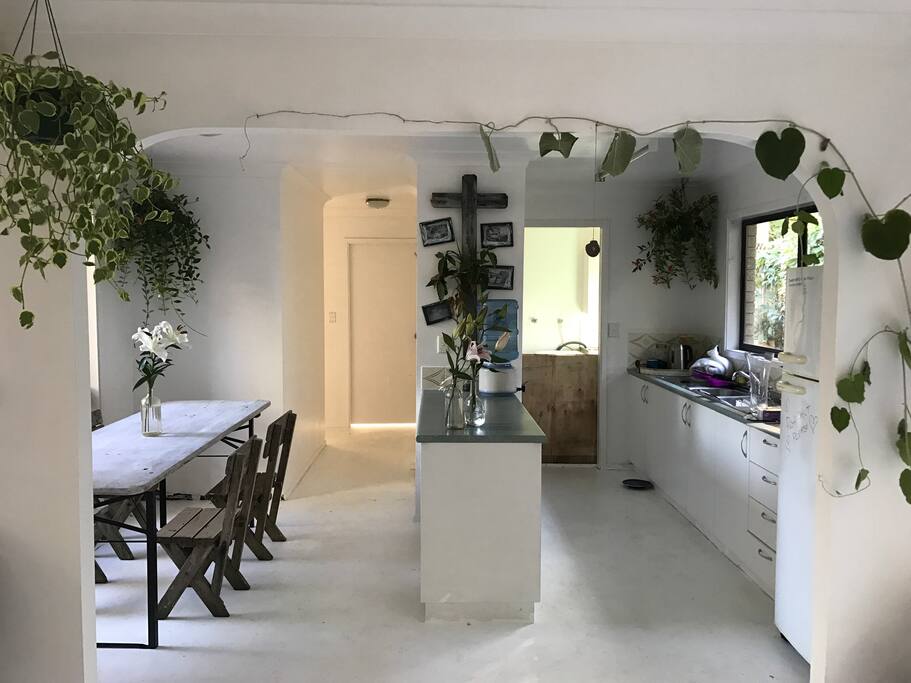 kitchen & dining area, a artist house it is what it is, white floors loads of plants. Basic kitchen wear. Y cook when the road house cafe is only footsteps away