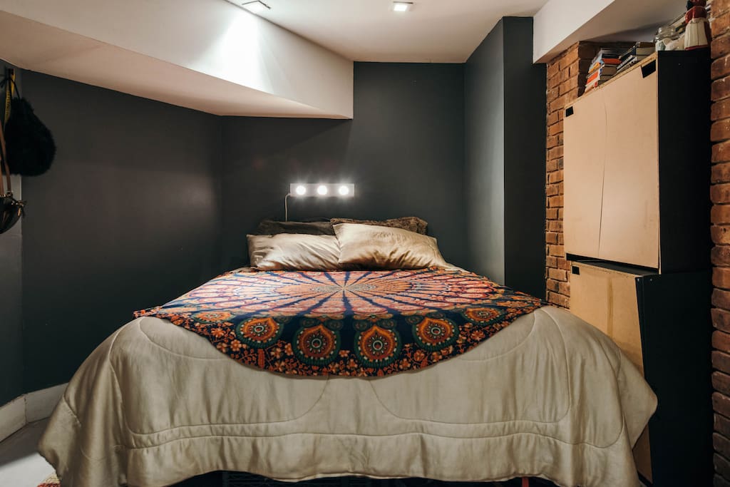 Queen size bed in private cove and a pull out sofa on the other side of the room.