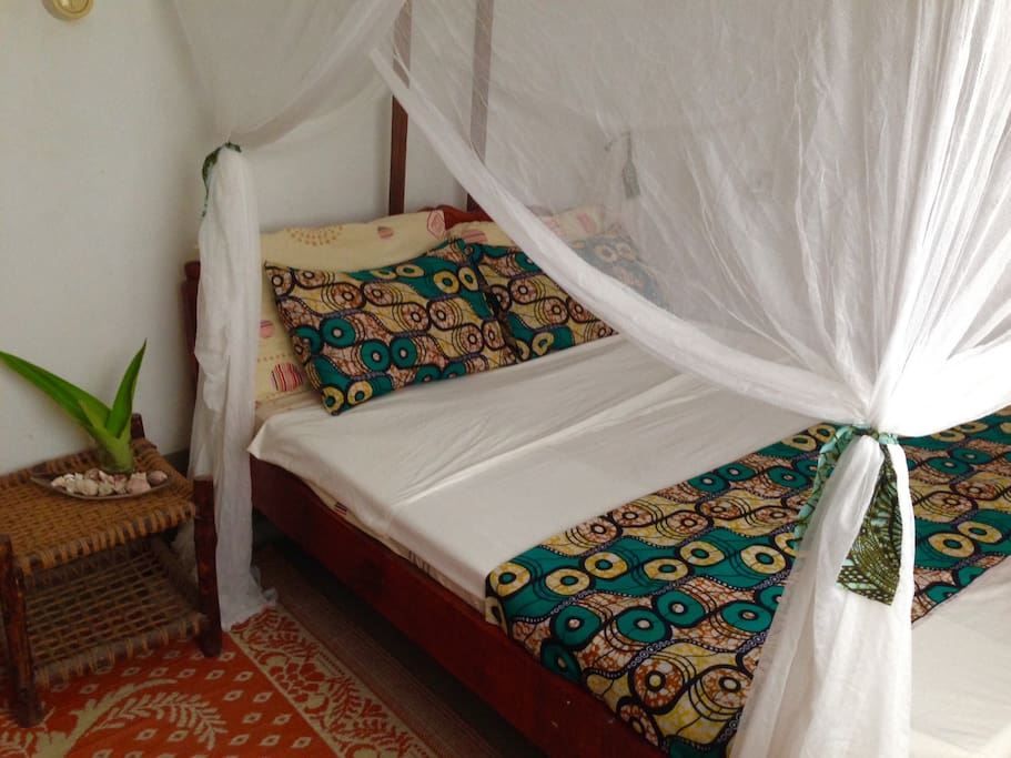 Bedroom 1: cozy doublebed, mosquitoned, fan and wardrobe
