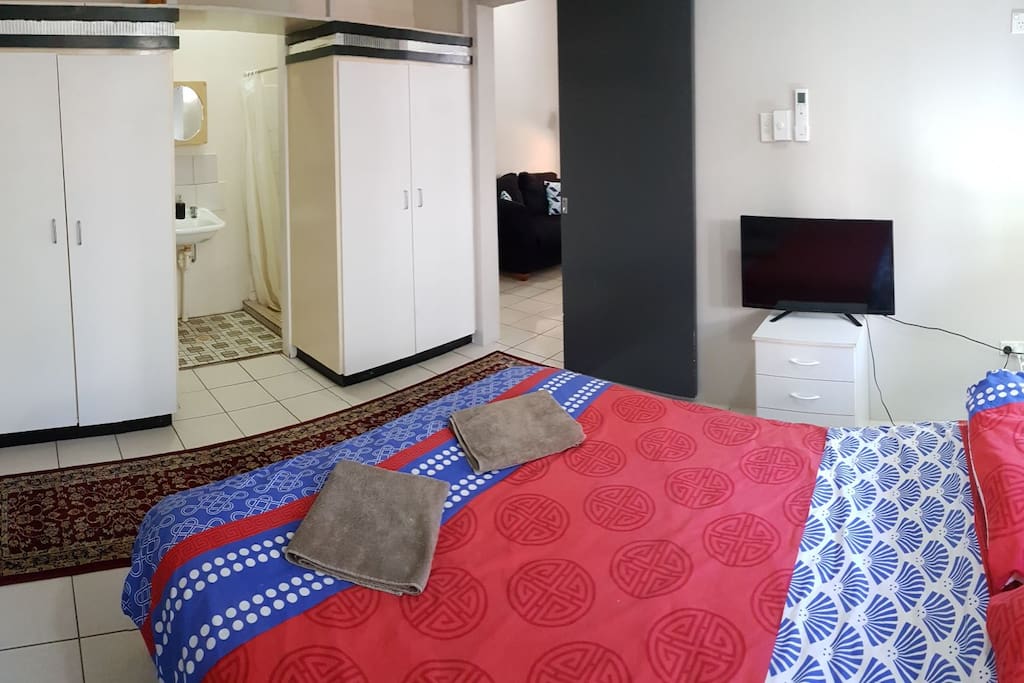 The bedroom has a queen size bed, TV, and plenty of storage space. The bathroom is accessed from the bedroom, and the bedroom can be closed off from the living area if required