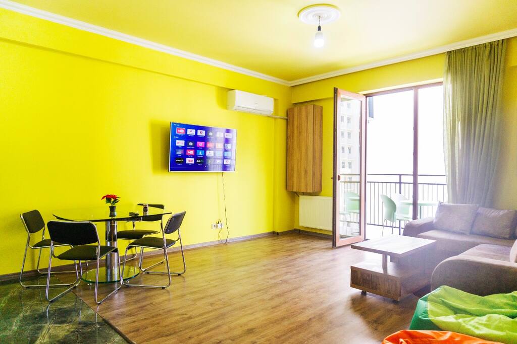 living room with folding sofa and smart tv